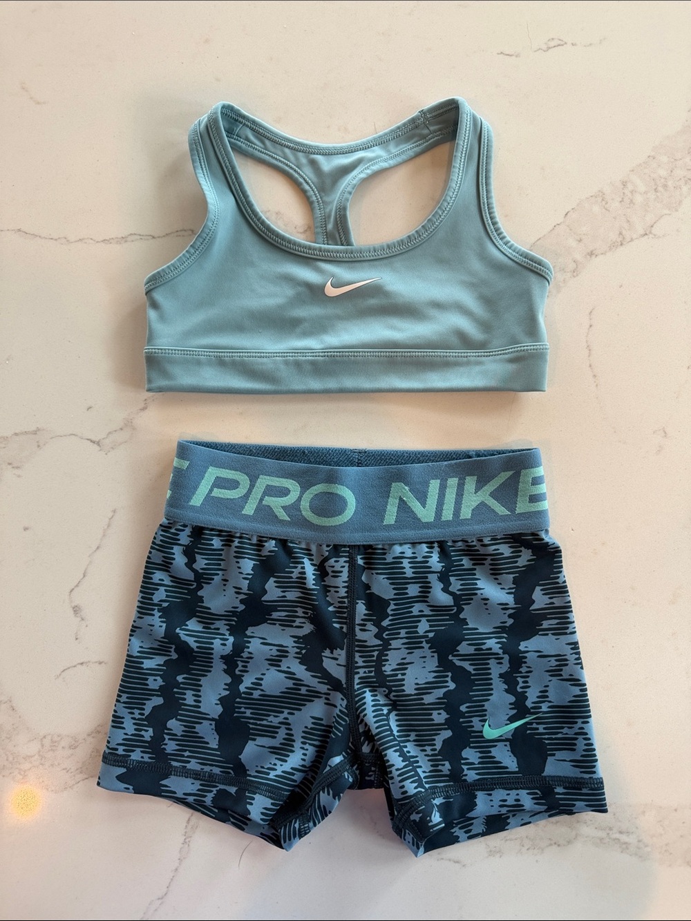 Girls Nike Light/Powder Blue Sports Bra and Patterned Navy Pro Shorts
